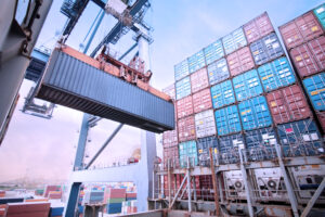 Container loading in a Cargo freight ship with industrial crane. Container ship in import and export business logistic company. Industry and Transportation concept.